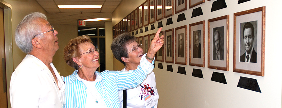 Olds College Alumni looking at Hall of Alumni photos