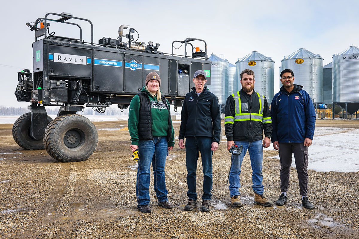 OMNiPOWER 3200 on the Olds College Smart Farm. Left to right: Shannon Oude Egberink, Research Assistant and student, Olds College; Roy Maki, Research Project Manager, Olds College; Caleb Janz, Service Technician, Raven; and Ashutosh Singh, Data Scientist, Olds College.